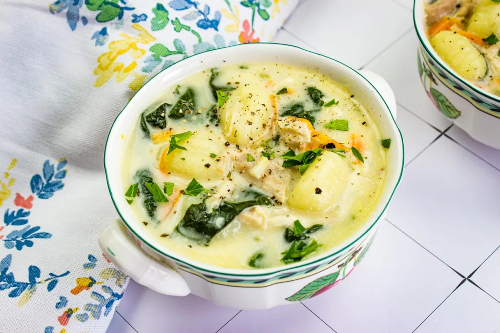 A bowl of chicken gnocchi soup.