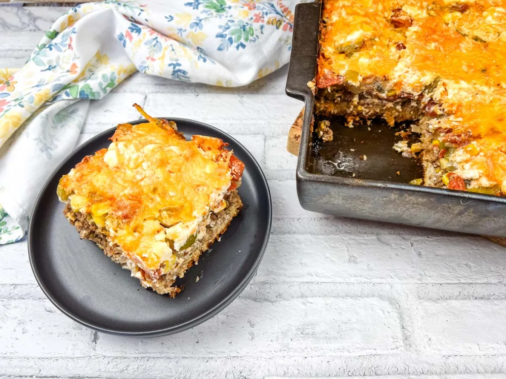 A tasty casserole on a black plate.