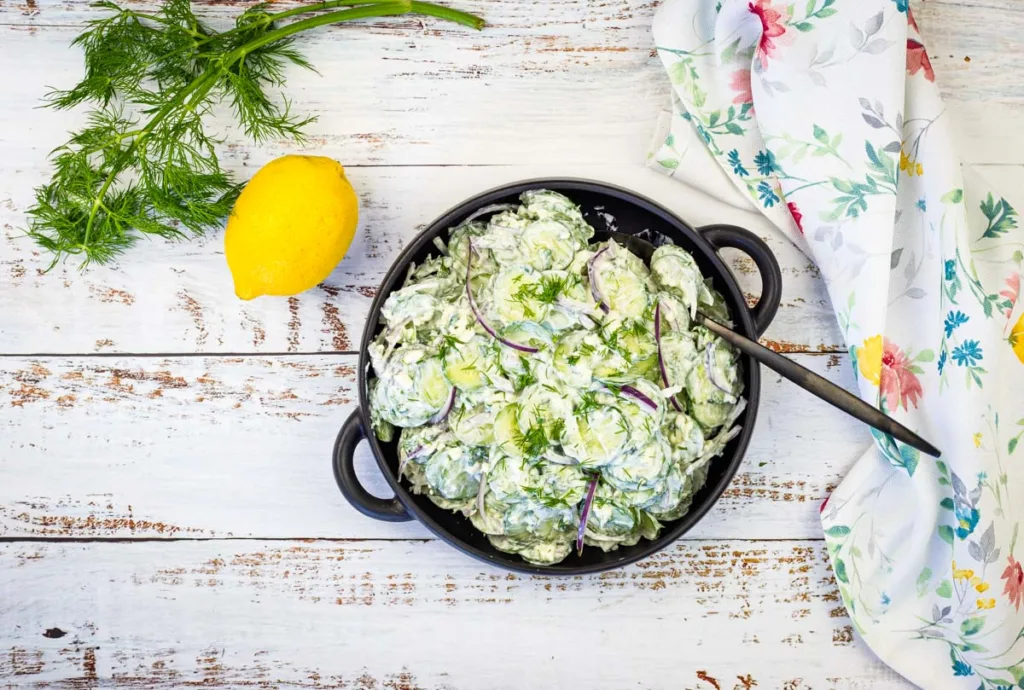 Top down image of Cucumber and Feta Salad in a black bowl.