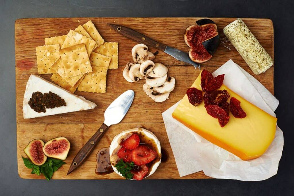 Charcuterie board with various foods on it.