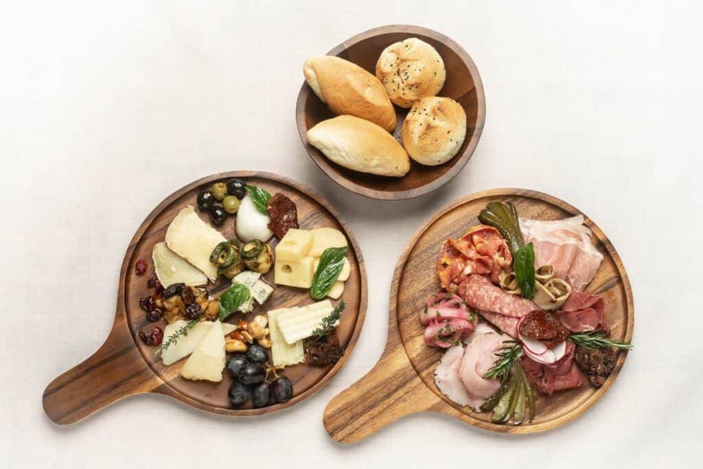 Charcuterie boards with various foods on them.