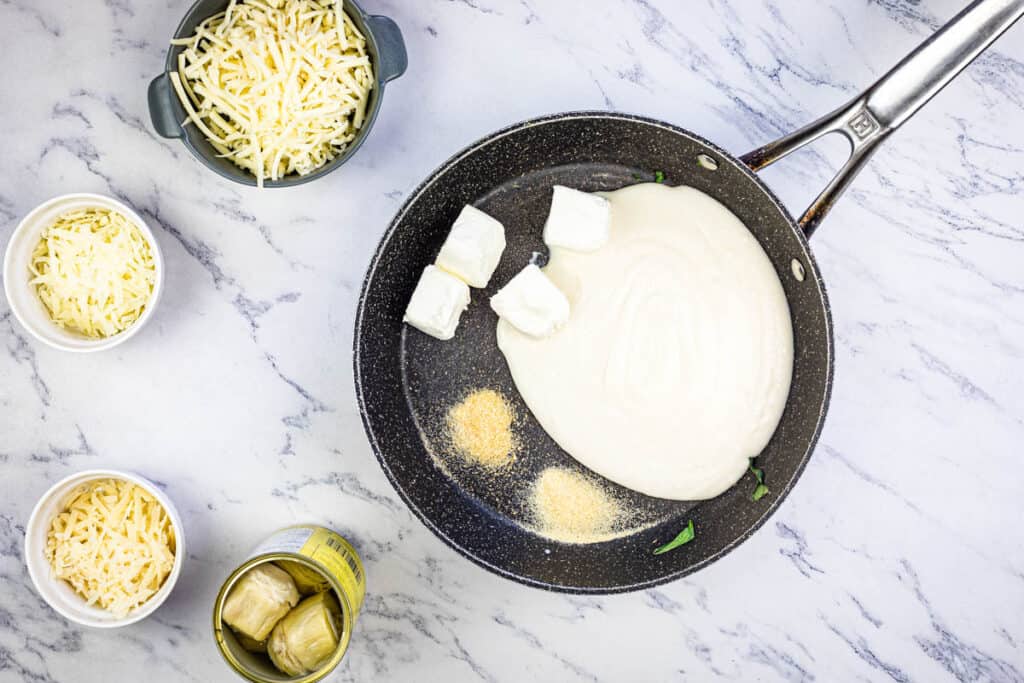 In a medium saucepan, heat Alfredo sauce, cream cheese, garlic powder, and onion powder, stirring until the cream cheese melts.