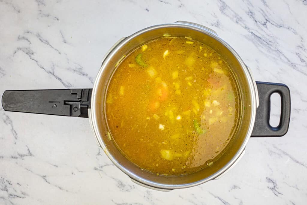 Add chicken broth and bring the mixture to a boil.