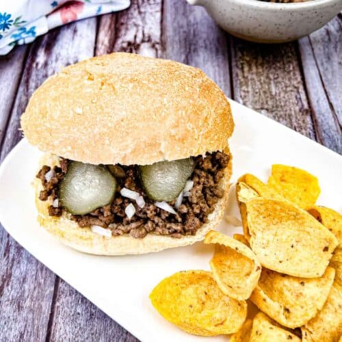 Copycat Maid-Rite Loose Meat Sandwich with chips on a white plate.