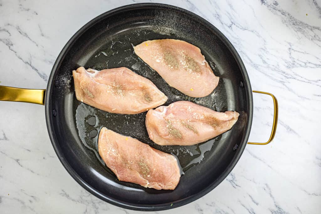 Add the chicken breasts and cook for about 2-3 minutes on each side, or until golden brown.