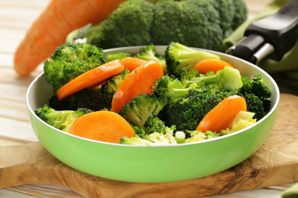 Freshly steamed vegetables in a pan.