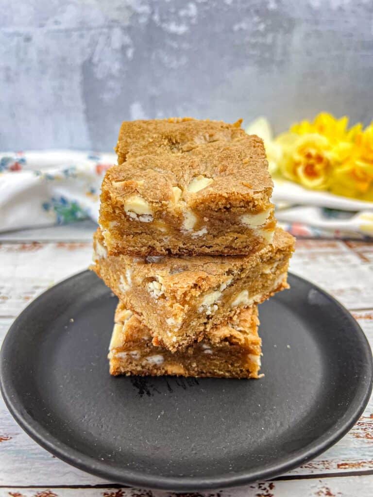 Speculoos White Chocolate Blondies on a black plate.