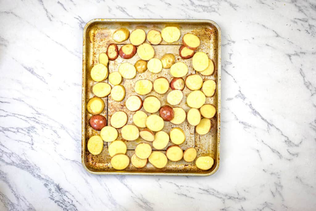 Toss baby potatoes with olive oil, salt, and pepper. Spread on a baking sheet in a single layer.