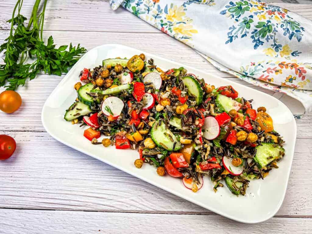 Horizontal image of wild rice salad on a white plate.