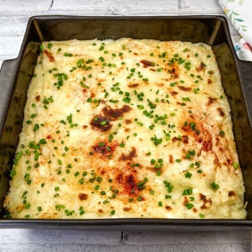 Grandma's Mashed Potato Casserole in a black baking dish.