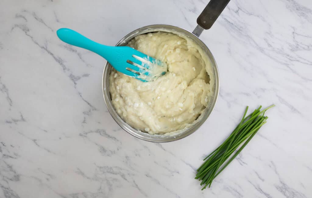 Mashed potato casserole mixture in a pot.