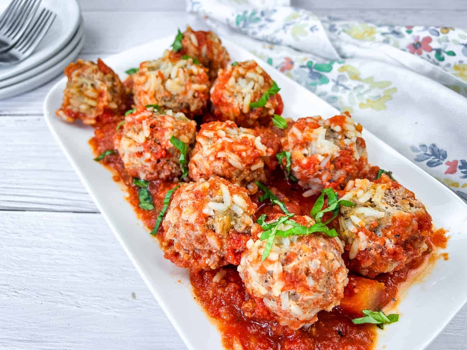 Then pieces of Slow Cooker Porcupine Meatballs on a white plate.