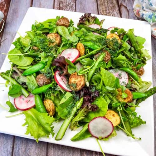 Spring salad on a white plate.