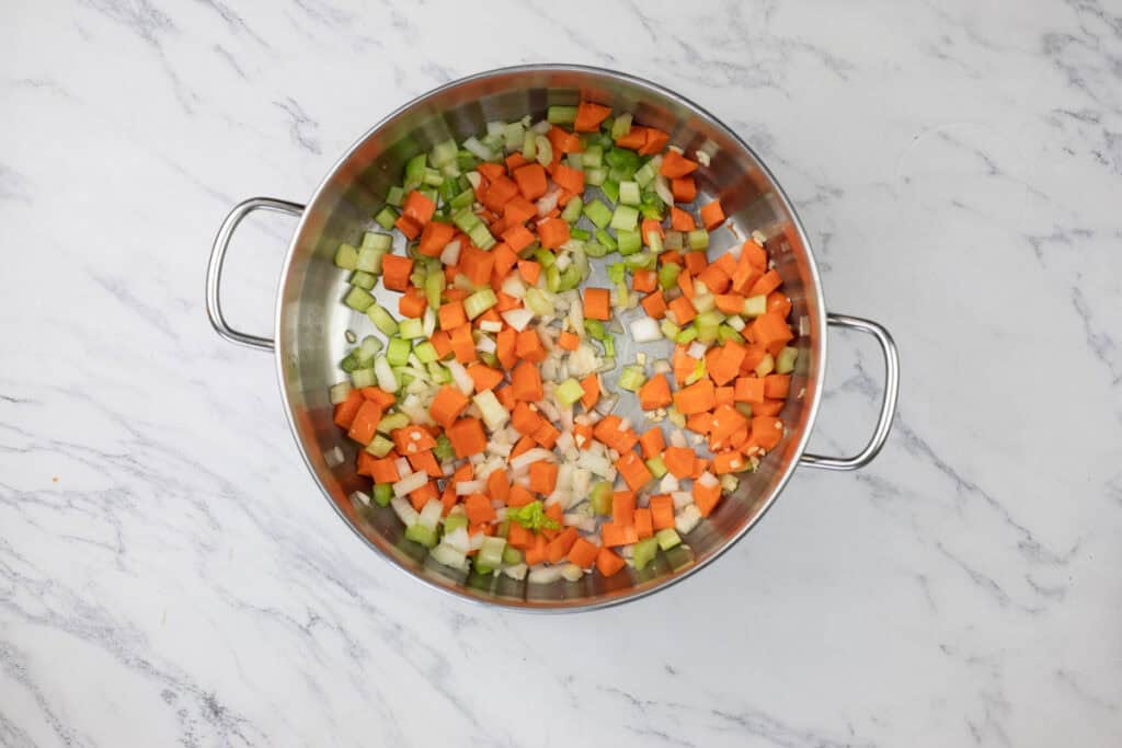 Cook diced onions, carrots, and celery until softened, about 5 minutes.