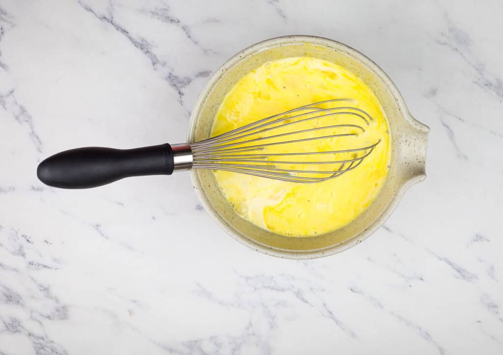 Whisk eggs, milk, salt, and pepper in a medium bowl until well combined.