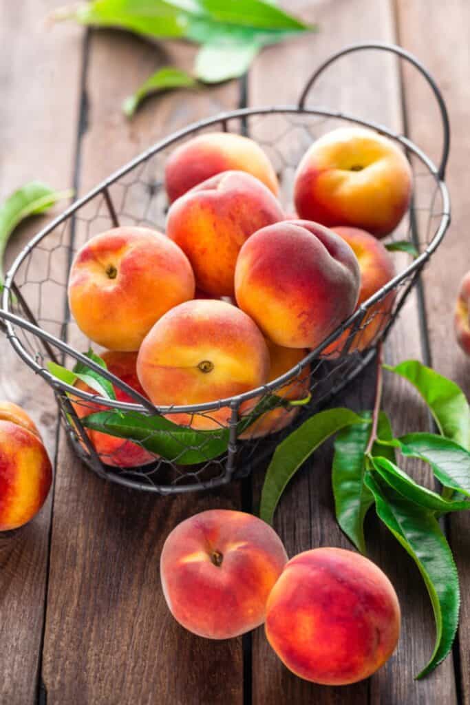 Fresh peaches with leaves.