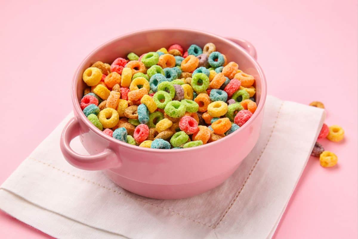 Colorful cereals in a a pink bowl.