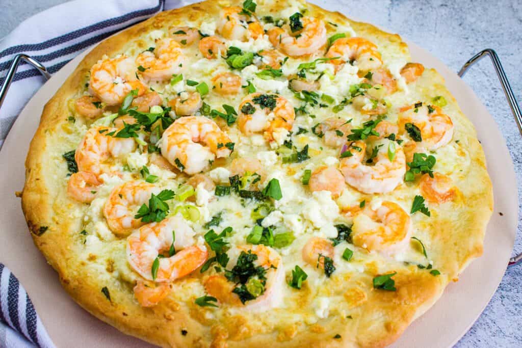 A shrimp scampi pizza loaded with melted cheese.