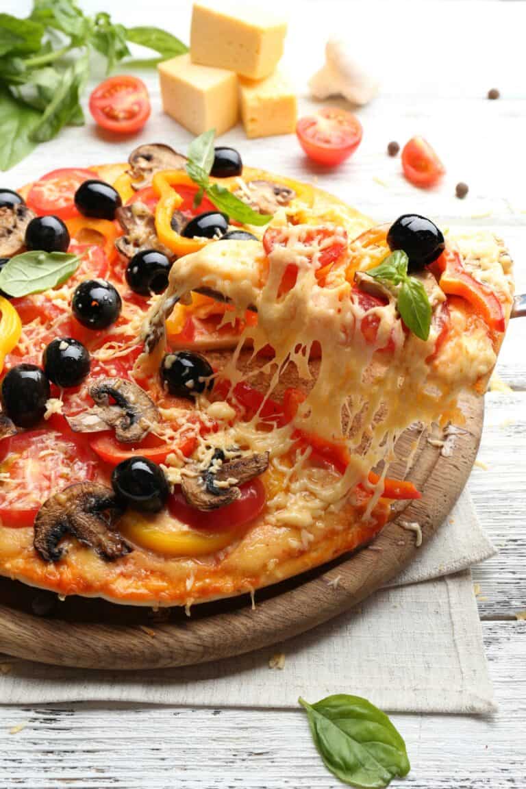 Delicious pizza served on wooden table.