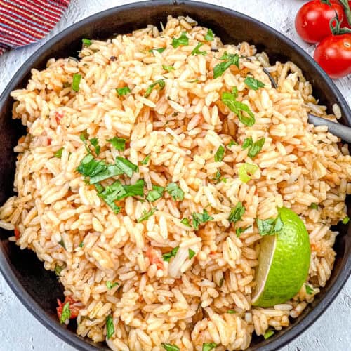 Mexican rice on a black bowl.