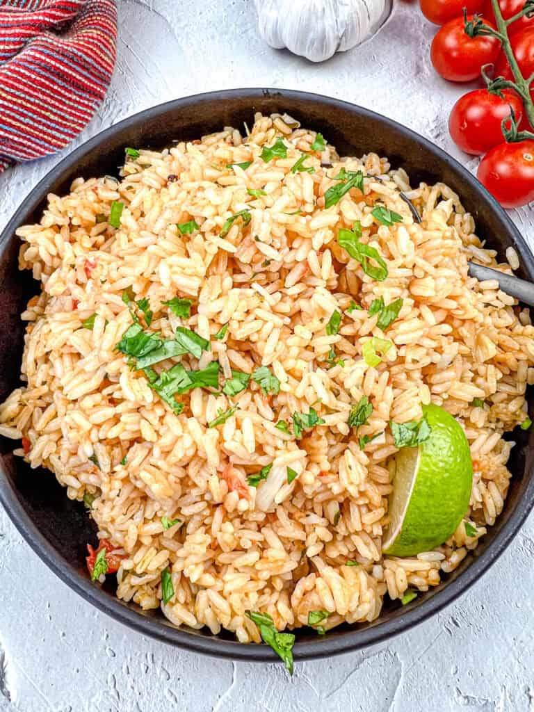 Mexican rice on a black bowl.