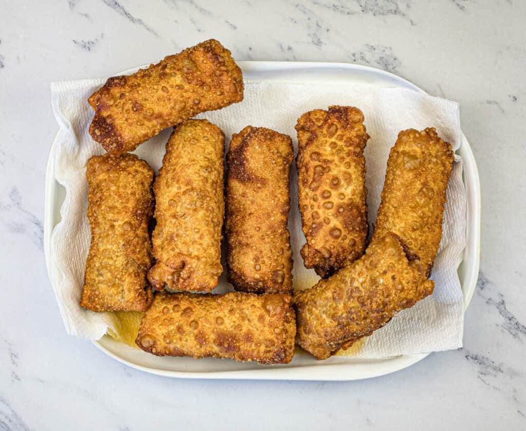 Remove the eggrolls from the oil using a slotted spoon and drain on paper towels.