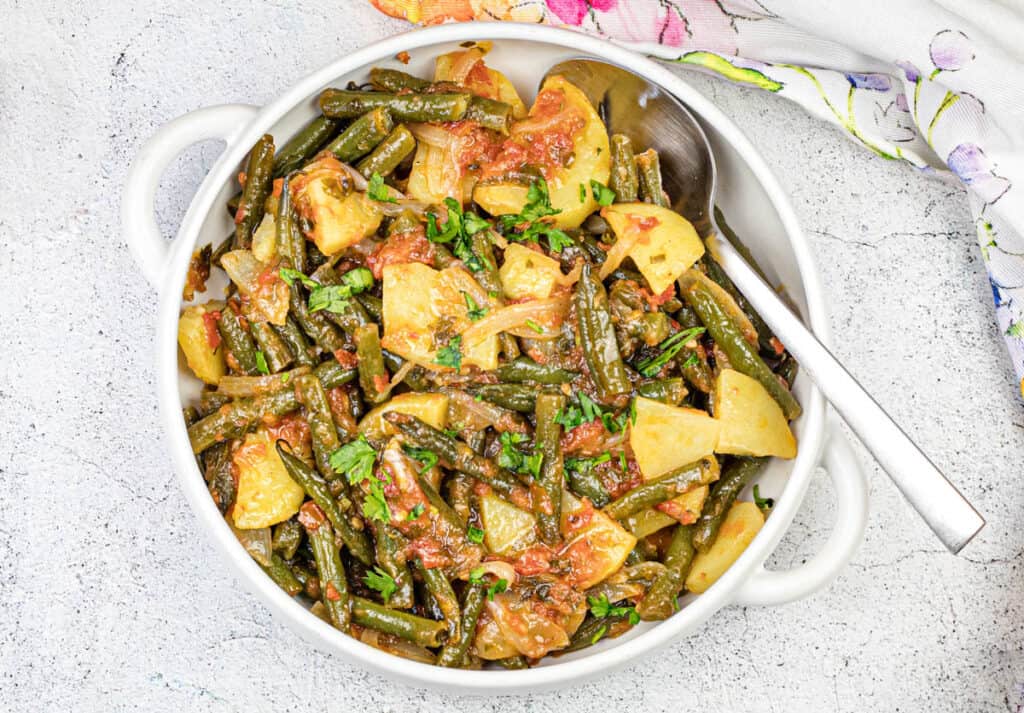 Top-down shot of Greek Green Beans served in a white bowl.