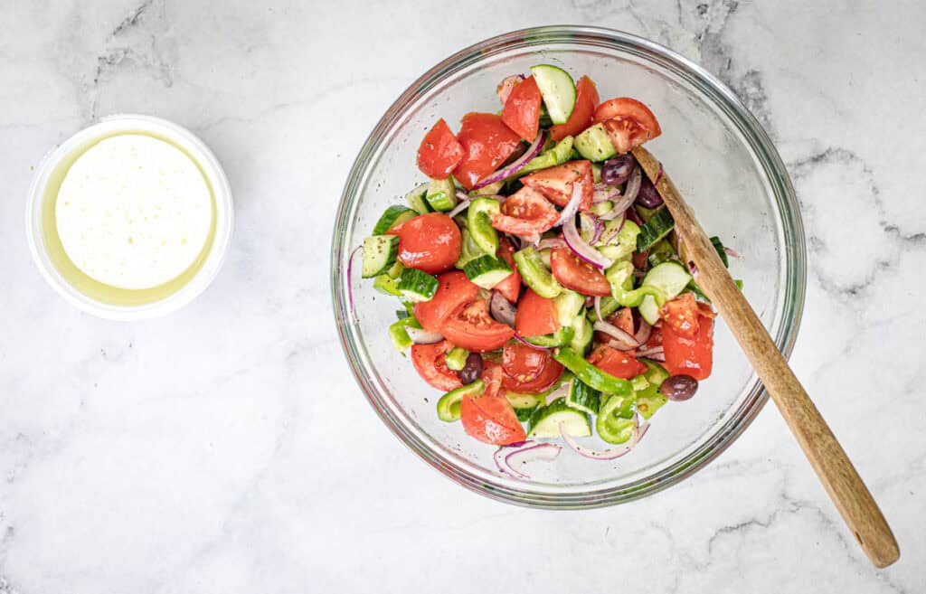 Transfer the salad to a serving bowl and lay or sprinkle the feta cheese over the top.