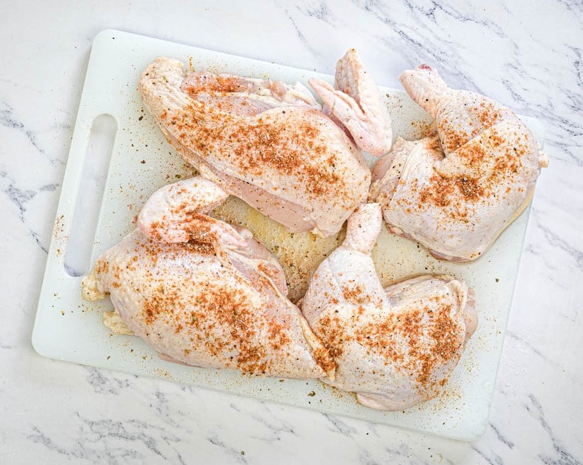 Season chicken with salt, paprika, cumin, and black pepper.