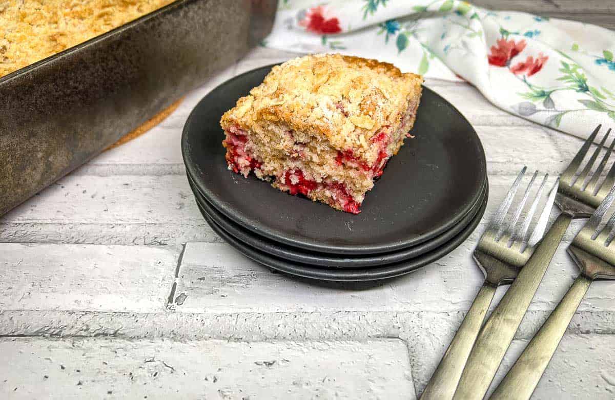 A piece of raspberry crumb cake on a plate.