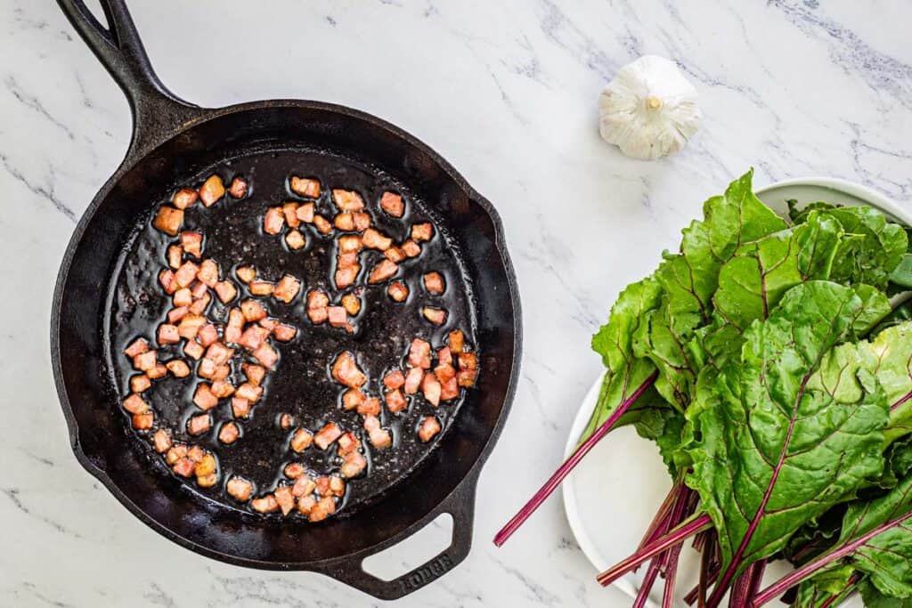 Add the pancetta to a large skillet and cook until it is brown.