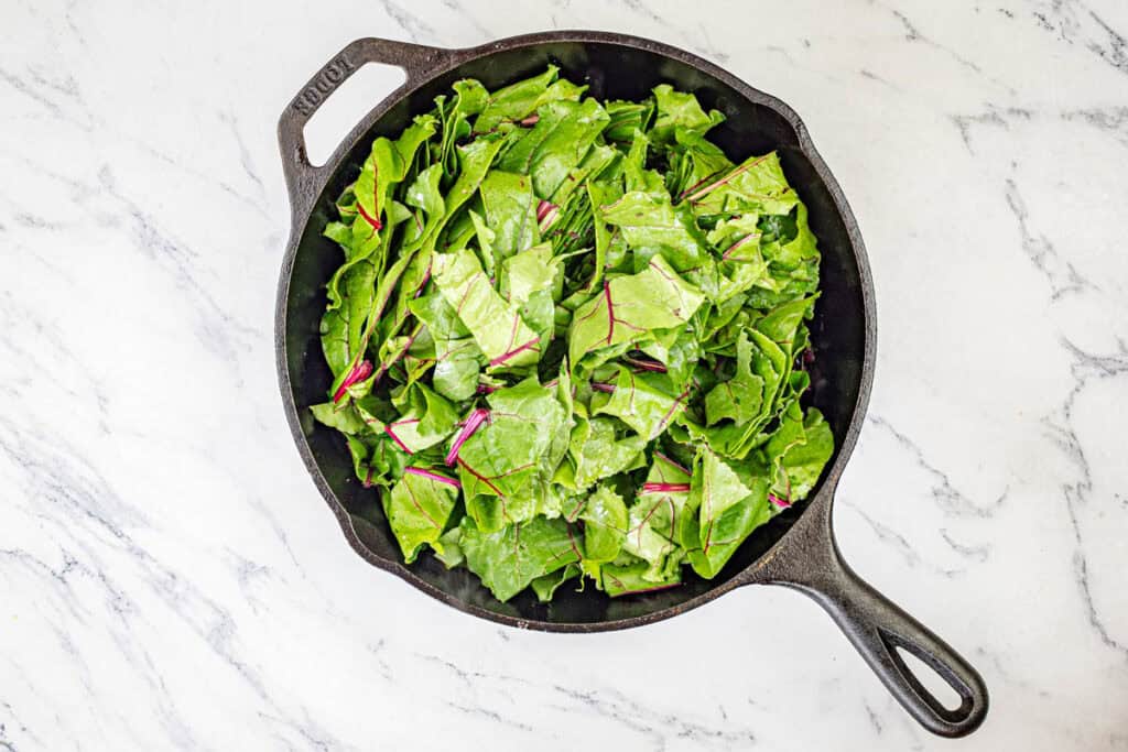 Wash the greens well and separate the stems from the leaves.