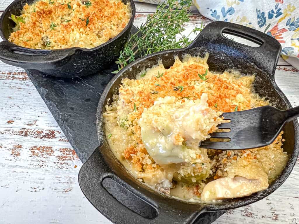 Chicken divan on a black bowl.