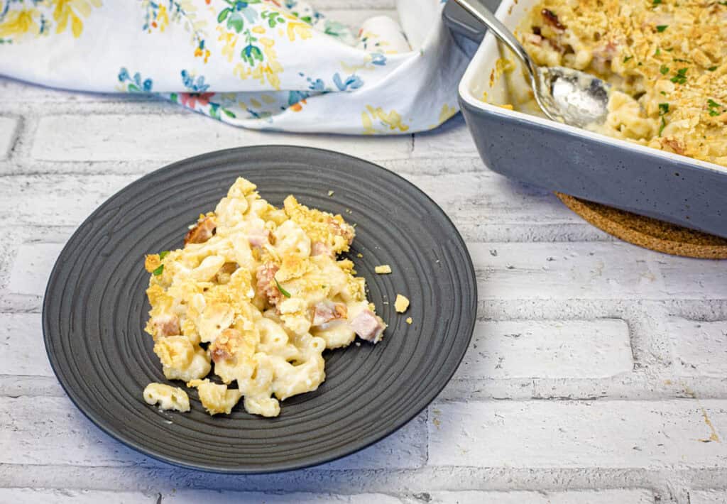 A portion of Old Fashioned Mac & Cheese on a black plate.