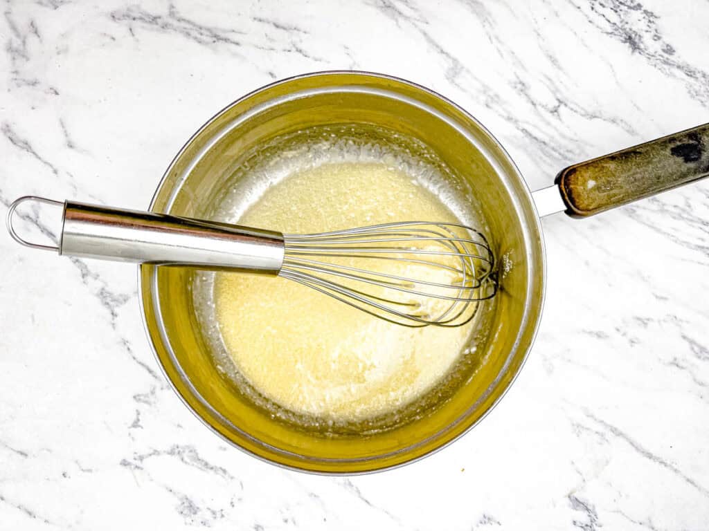 Melt ¼ cup of butter in a skillet or saucepan and then add the flour.