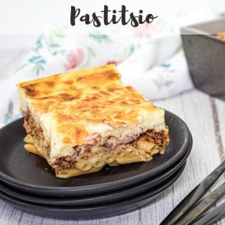 Pastitsio on a black plate.