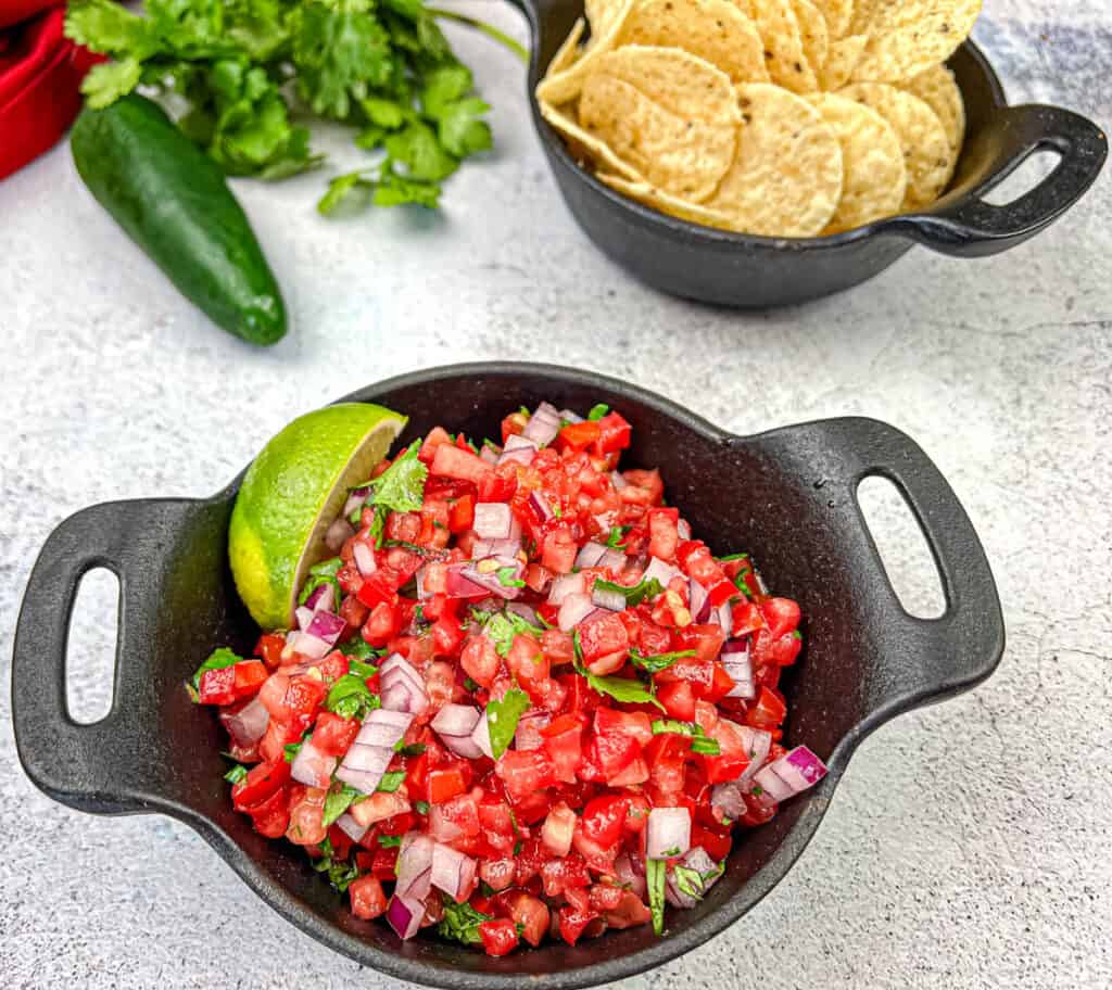 Pico de Gallo on a black cast iron bowl.