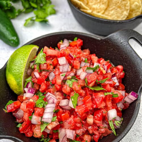 Pico de Gallo on a black cast iron bowl.