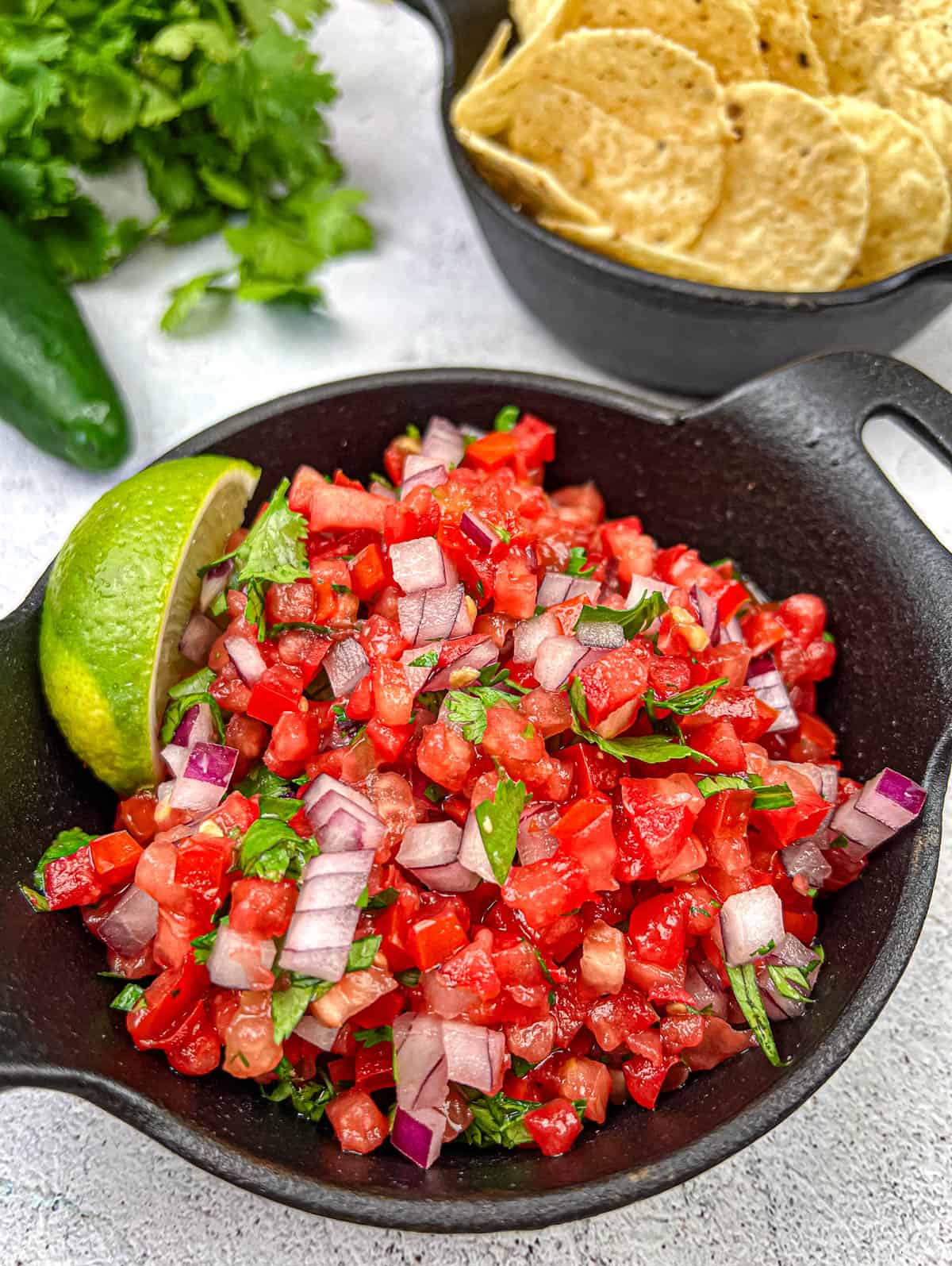 Pico de Gallo on a black cast iron bowl.