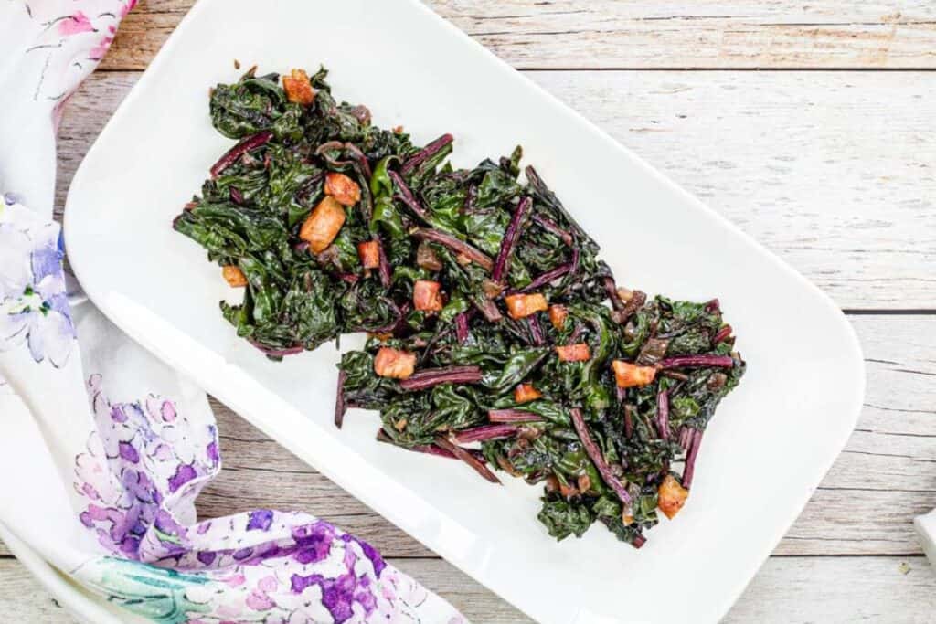 Top-down shot of a plate of Sauteed Beet Greens with Pancetta.