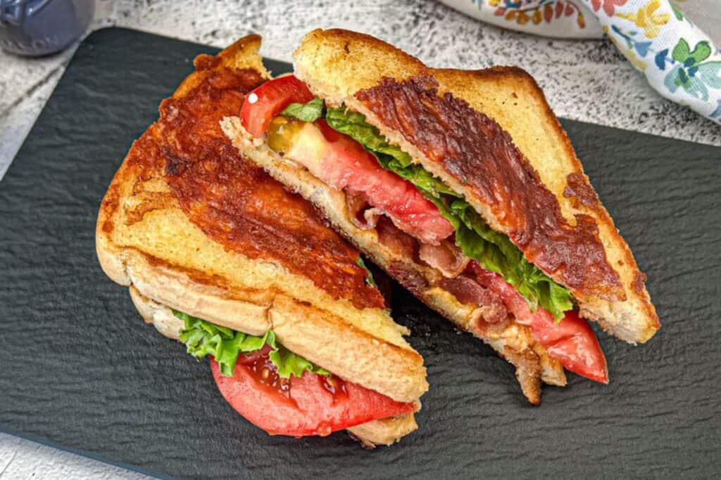 Texas BLT on a black slate plate.