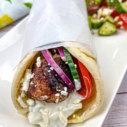 Greek Meatball Pita Sandwich on a white plate.