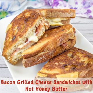 Bacon Grilled Cheese Sandwiches with Hot Honey Butter on a white plate.