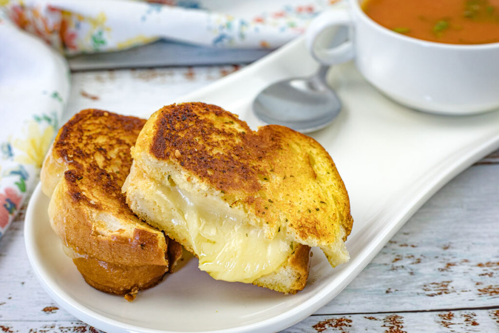 Close-up pieces of Garlic Bread Grilled Cheese on a plate.