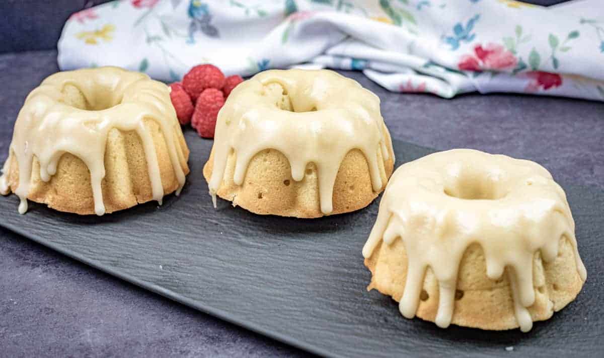 Three mini bundt  Buttermilk Cake with Brown Sugar Glazes on a slate platter.