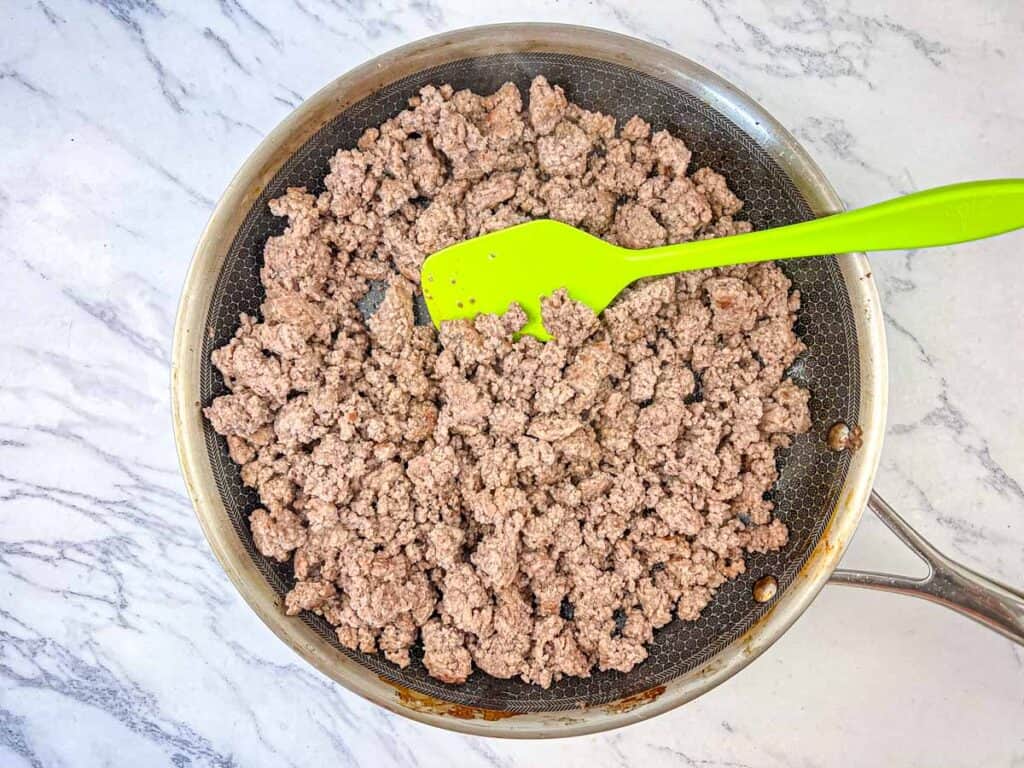 Cook ground beef with steak spice until browned,