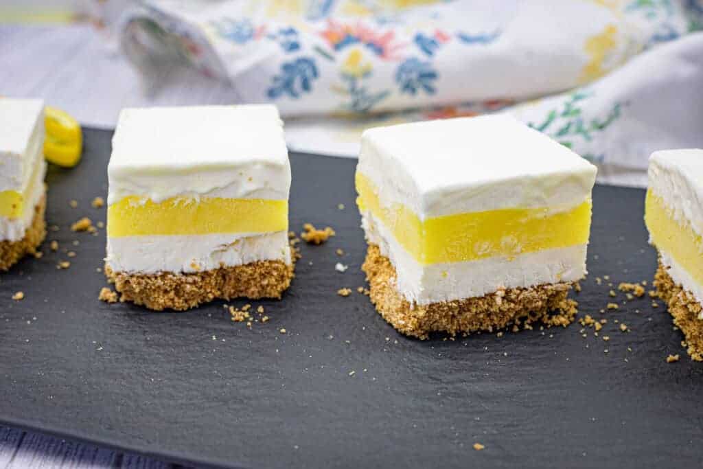 Close-up pieces of lemon lush on a slate plate.