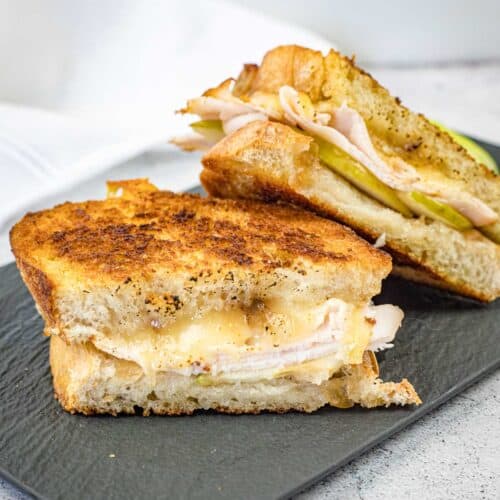 Turkey & Apple Grilled Cheese on a slate plate.