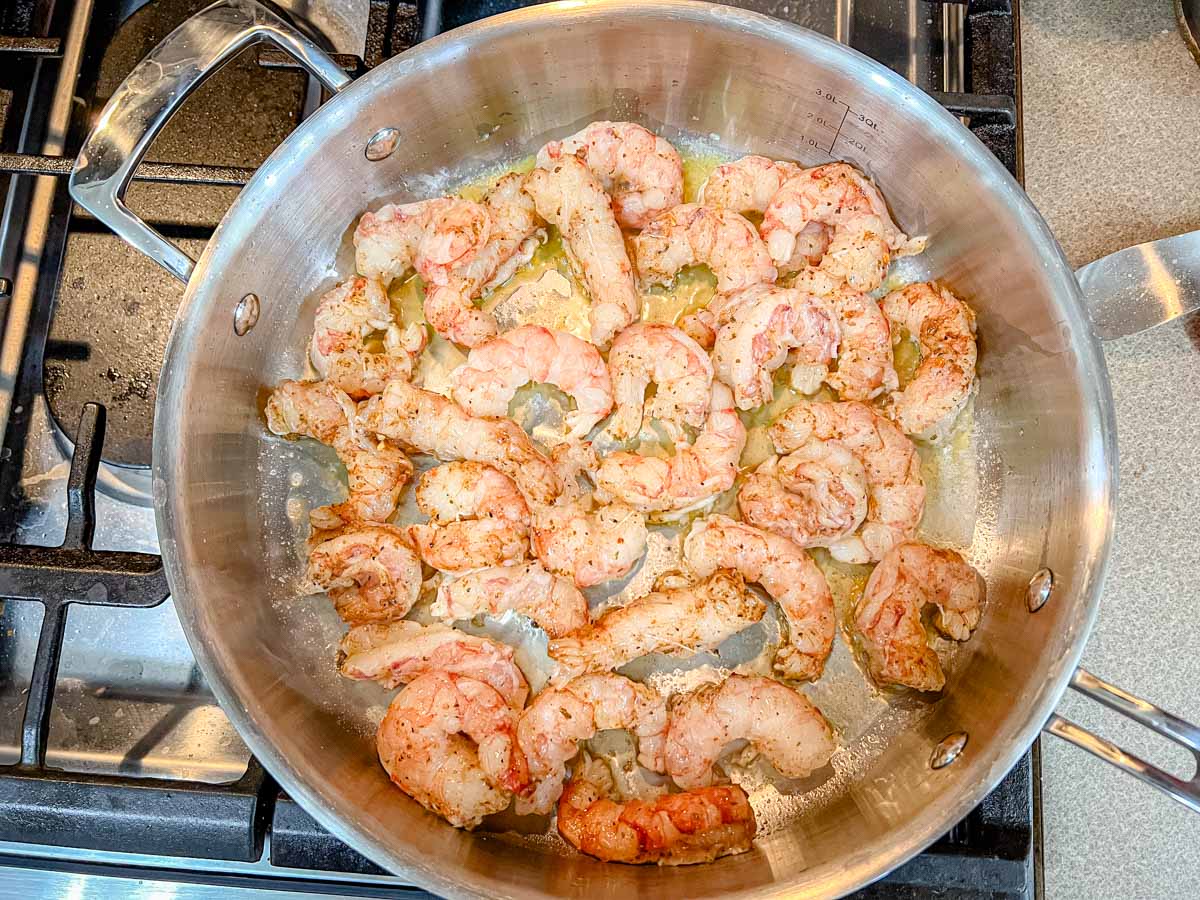 Saute the shrimp in the hot butter until just barely cooked.