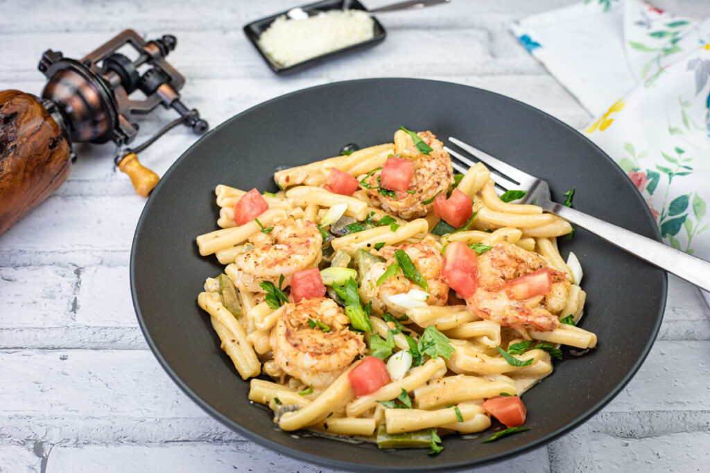 Cajun Pasta with Shrimp on a black plate.